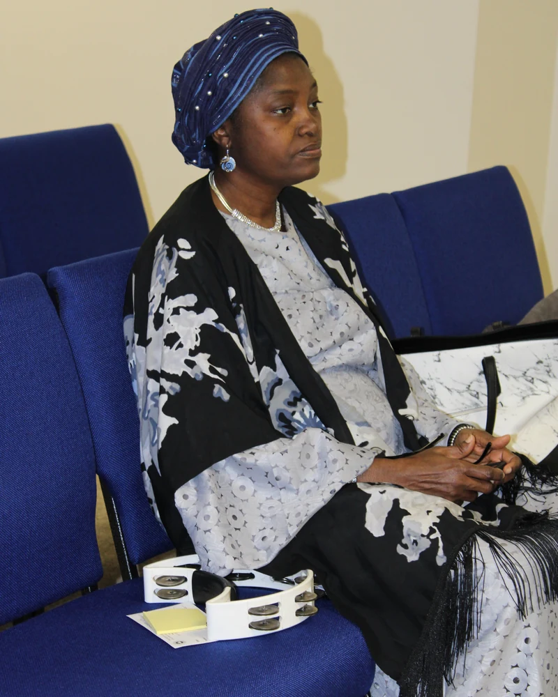 Portrait of the pastor’s wife seated in the church.